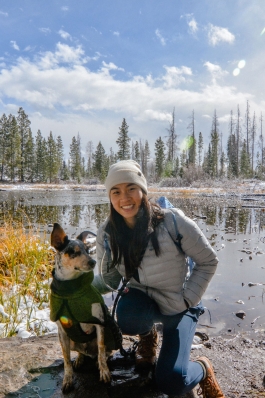 Samantha Sitt alongside a snow-dusted lake with her dog in Colorado