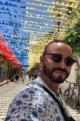 Juan Vargas underneath flags