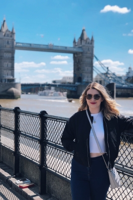 Katy Magliozzi standing in front of a bridge