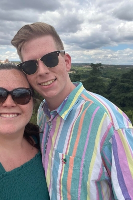 A photo of Dylan and a woman with the city of Madrid in the background