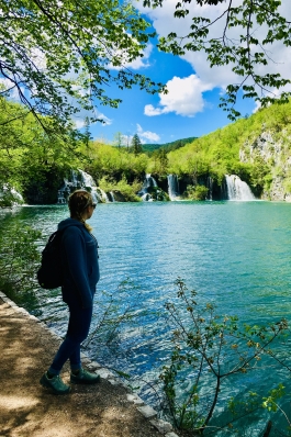 A photo of Anna overlooking a lake while visiting Croatia.