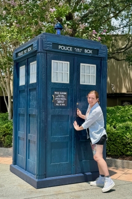 A photo of Jesi next to a Dr. Who telephone booth.