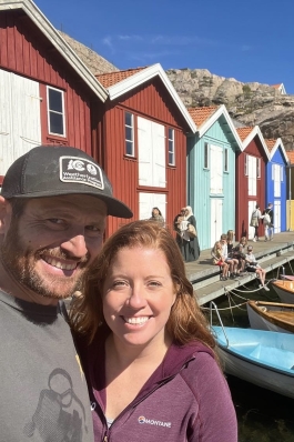 A photo of Rachel next to colorful buildings in Sweden.