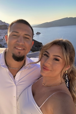 A photo of Larisa and her partner behind an ocean view.