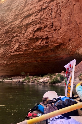 Allison Jones paddling a raft full of camping gear in the Grand Canyon
