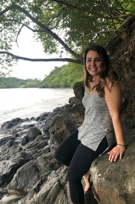 Ashlyn Johnson on a rocky shoreline in Costa Rica