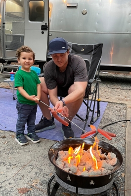 Gray Lawry and his son roast hot dogs over a fire pit in north Georgia