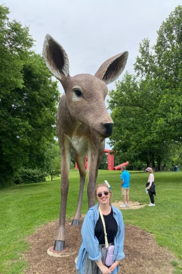 Keely Parker with a giant deer statue in St. Louis