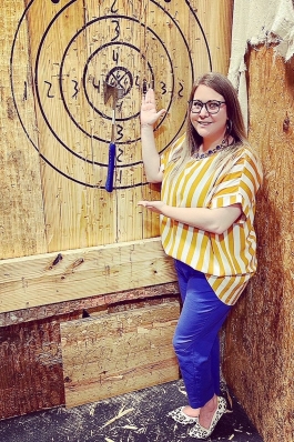 Kiki Mannear shows off her axe throwing score