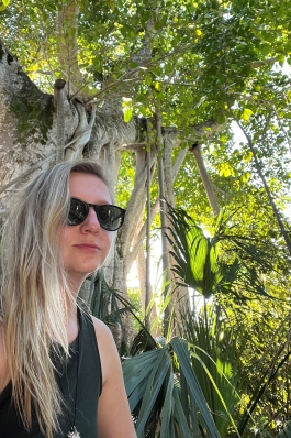 Samantha Sommers next to a banyan tree in Miami, FL