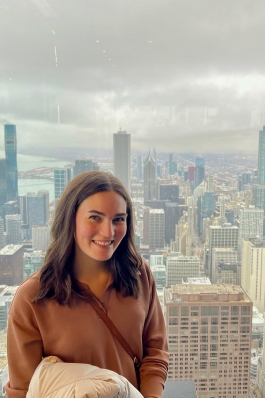 woman high up in a building in front of a city scape