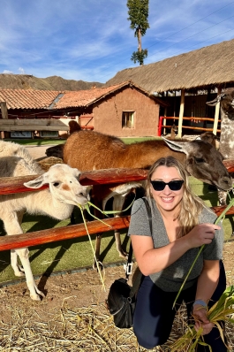 Ashley Hughes smiling with Lamas