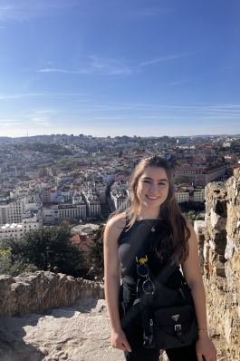 A photo of Lillian with the city of Lisbon as a backdrop