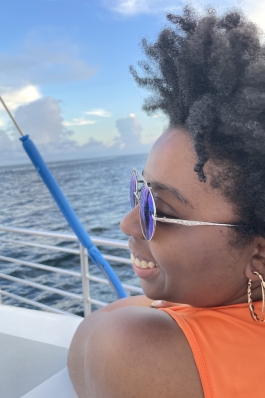 A photo of Melanie on a boat with the sea in the background