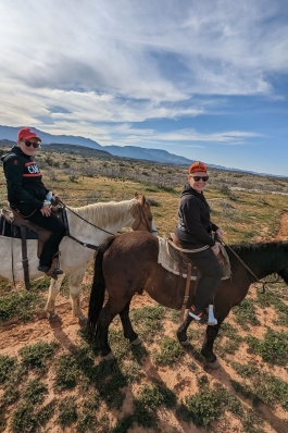 A photo of Lori and her partner on horseback in Arizona