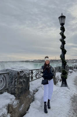 A photo of Tenzin in front of Niagara Falls, Canada