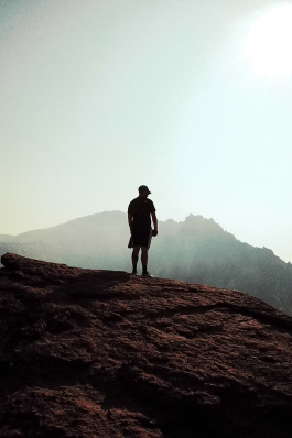 A cinematic photo of Josh on top of a hill.
