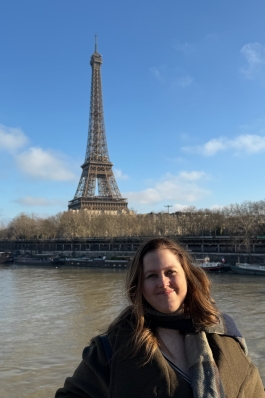 A photo of Angela in front of the Eiffel tower.