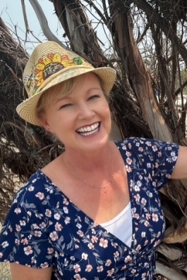 A photo of Missy posing with trees.