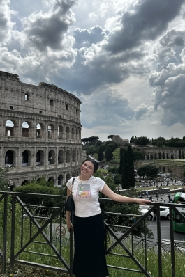 A photo of Maya with the Rome coliseum in the background.