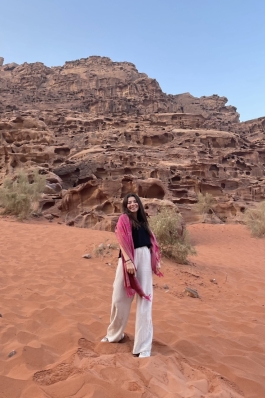 A photo of Maya in a desert in Jordan.