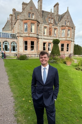 A photo of August posing near a historical building.