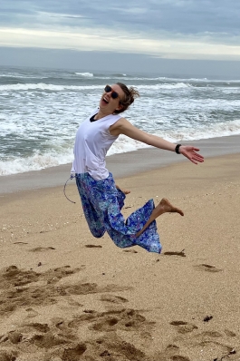 A photo of Joy jumping on the beach.